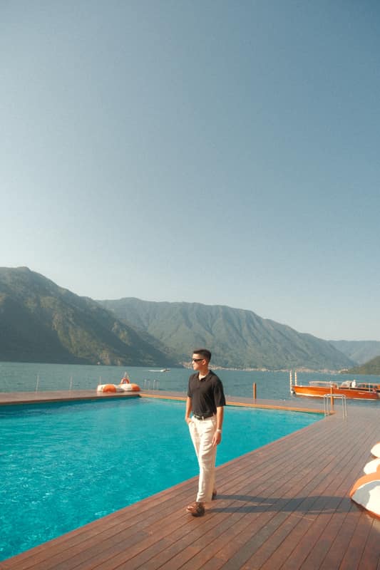 Jerome by an infinity pool above the lake